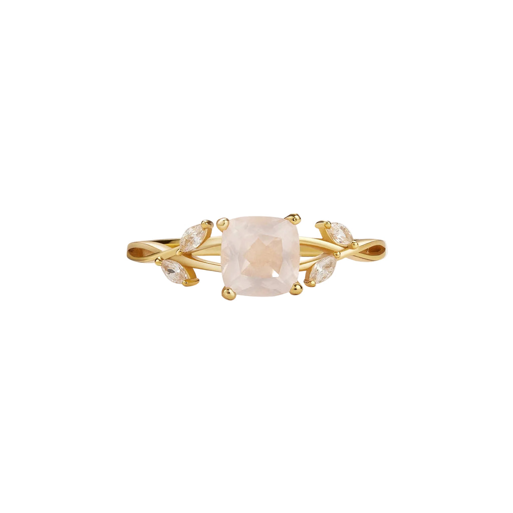 Gold ring with a pink gemstone on a white background