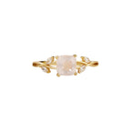 Gold ring with a pink gemstone on a white background